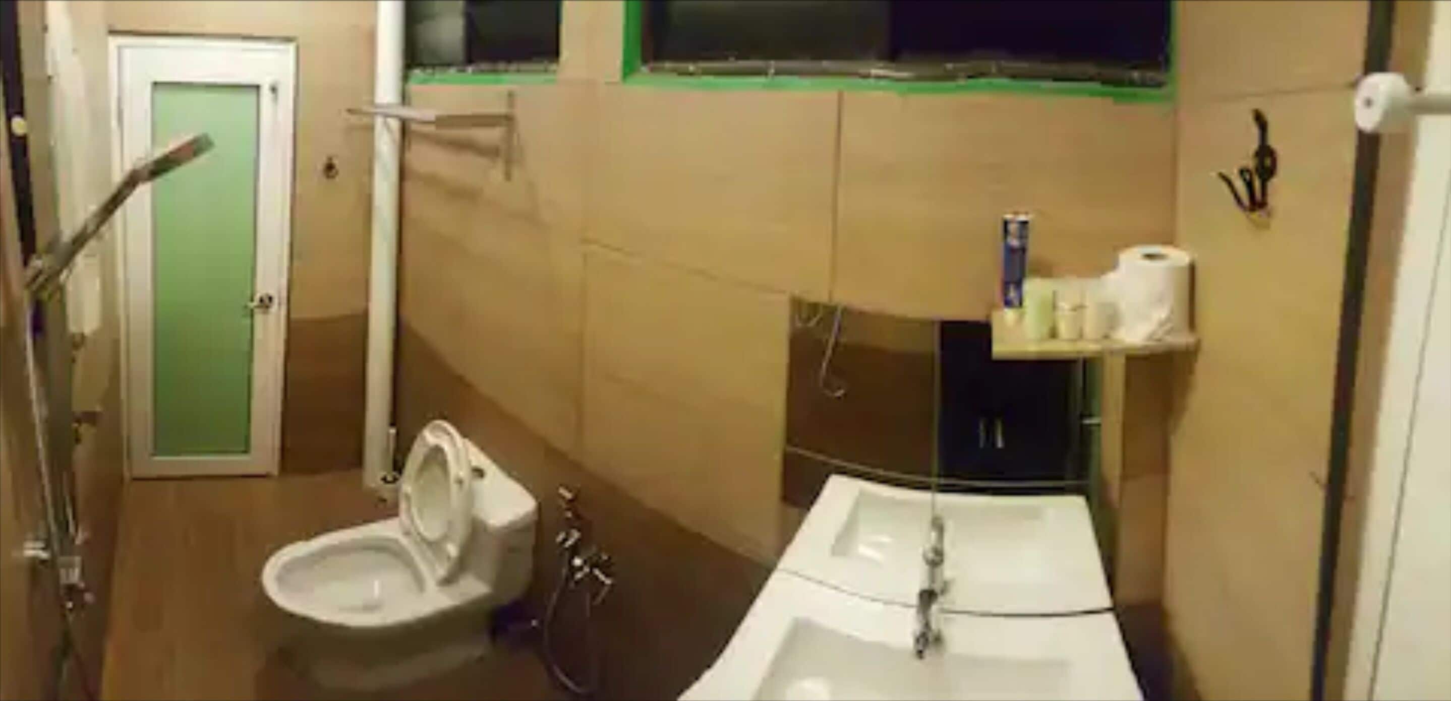 A bathroom with a toilet, sink, and shower.