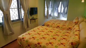 A bedroom with two beds, a TV on the wall, and curtains on the windows. - Jonker Hijau-Hijau Malacca (Malacca City)