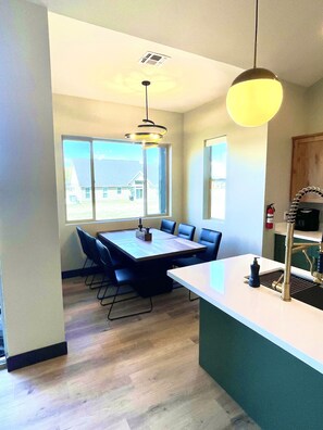 Enjoy meals in the spacious kitchen and dining area, featuring a central island, oven, and microwave.