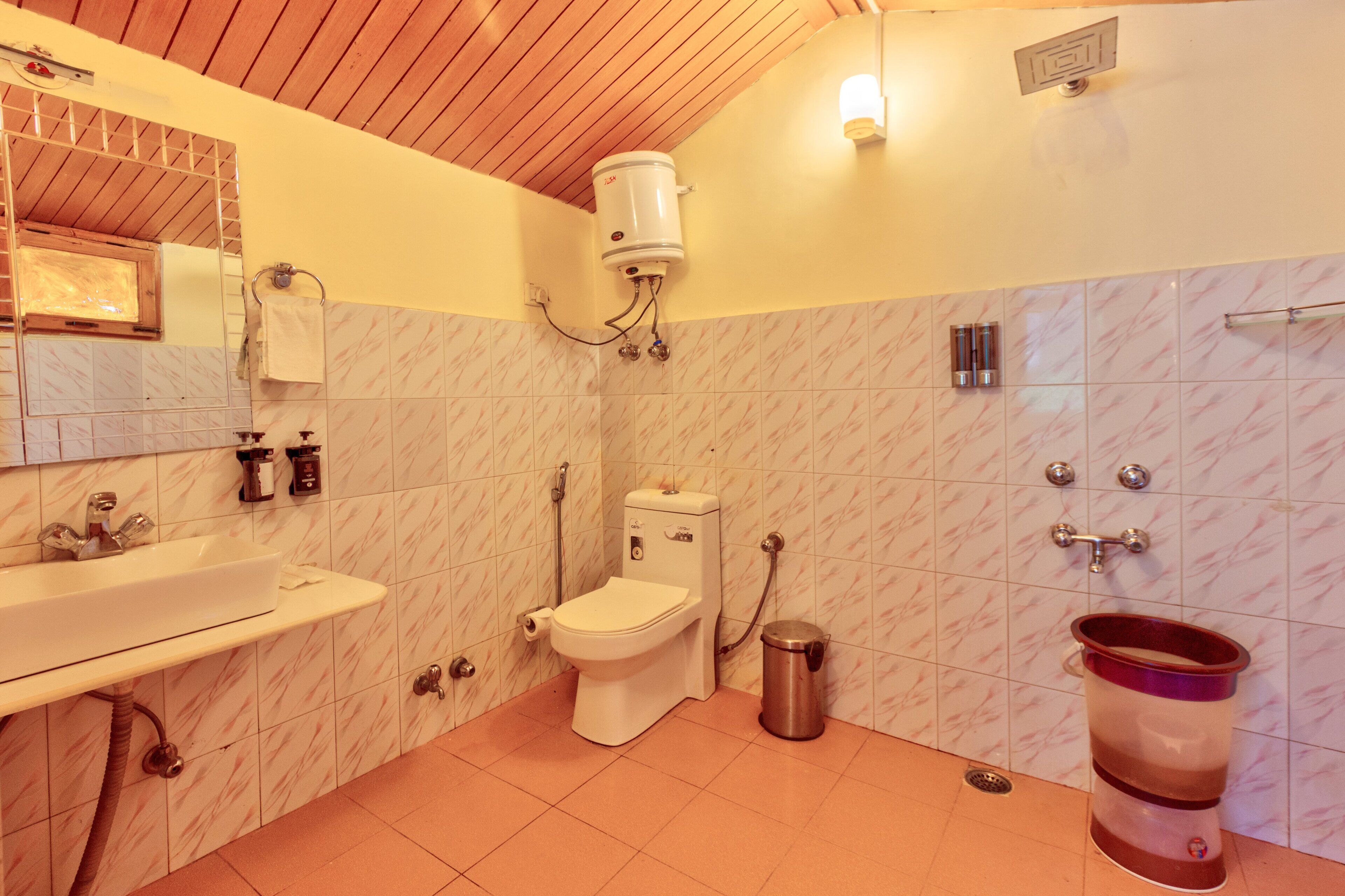 A bathroom with a toilet, sink, and a bidet.