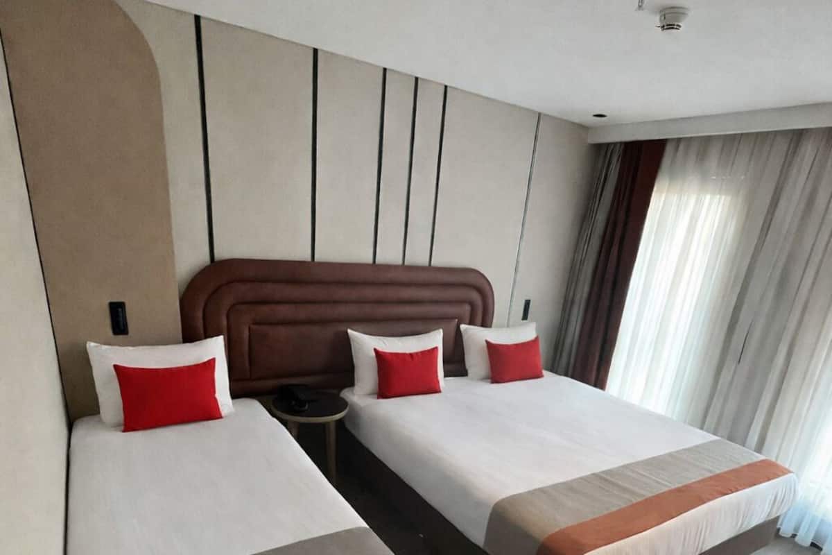 Family Triple Room | Minibar, in-room safe, individually decorated, individually furnished