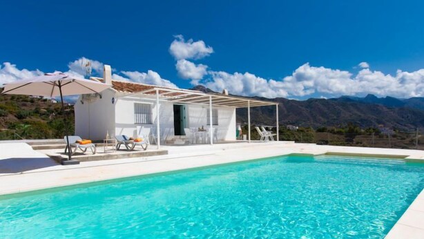 A modern villa with a swimming pool, outdoor seating, and a mountain view. - Las Vistas by Interhome (Torrox Costa)