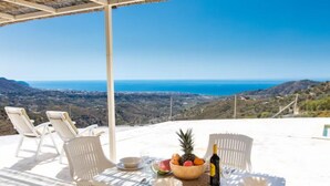 A table set for two with a view of the sea and hills. - Las Vistas by Interhome (Torrox Costa)
