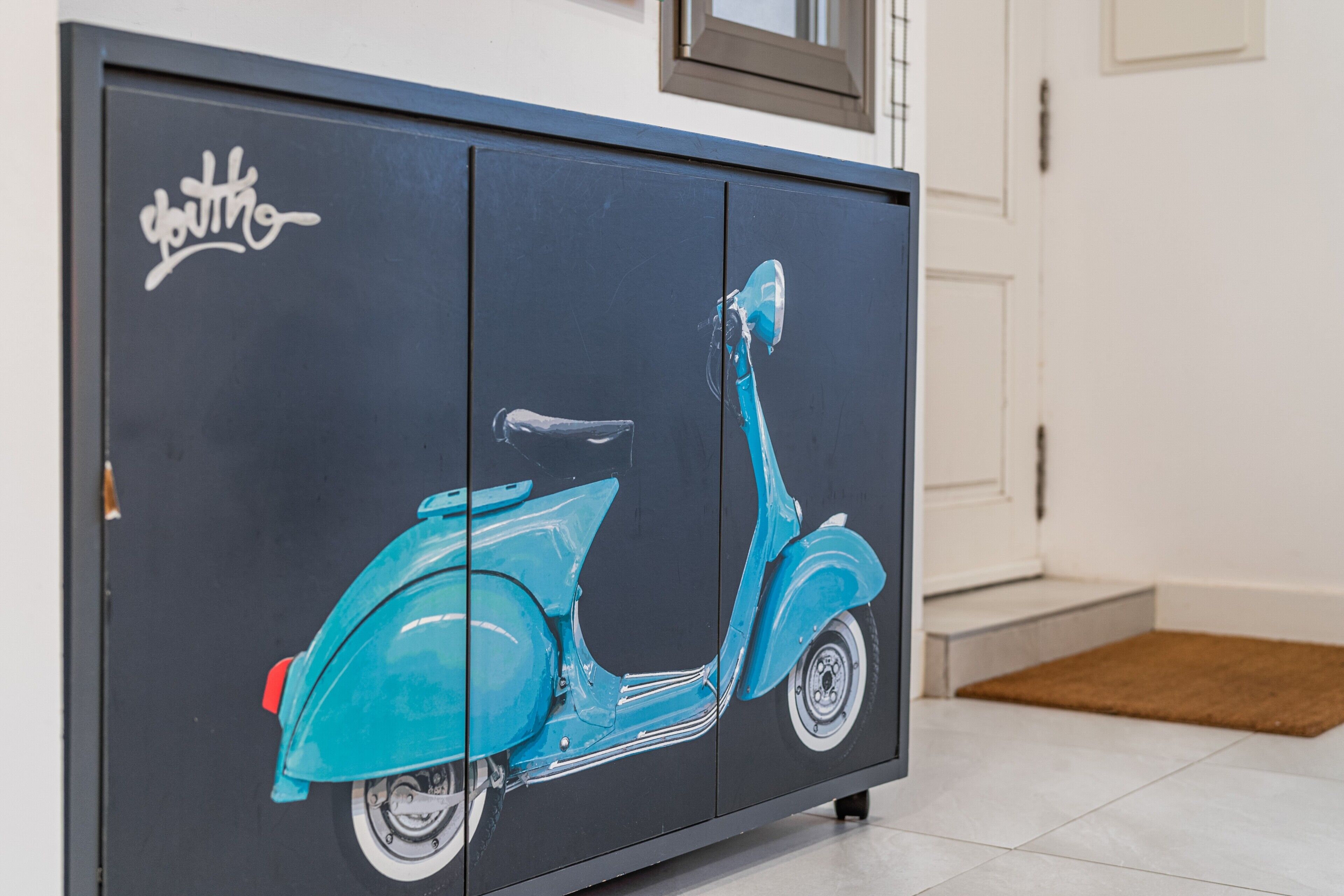 A black cabinet with a teal scooter graphic and the word 'youth' on it.