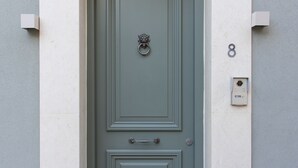 A green door with a knocker, a mail slot, and a doormat. - Located in the Heart of Heraklion, combining Elegance & Modern Luxury.  (Iraklio)