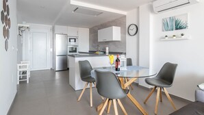 A modern kitchen with white cabinets, a built-in microwave, and a refrigerator. - 'Apartment ARCE Frontline Seaview' with Pool, Balcony & Wi-Fi (Nerja)