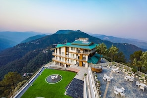 A hotel with a rooftop terrace, a well-maintained lawn, and a scenic mountain view. -  Regenta Hilltop Shimla (Shimla)