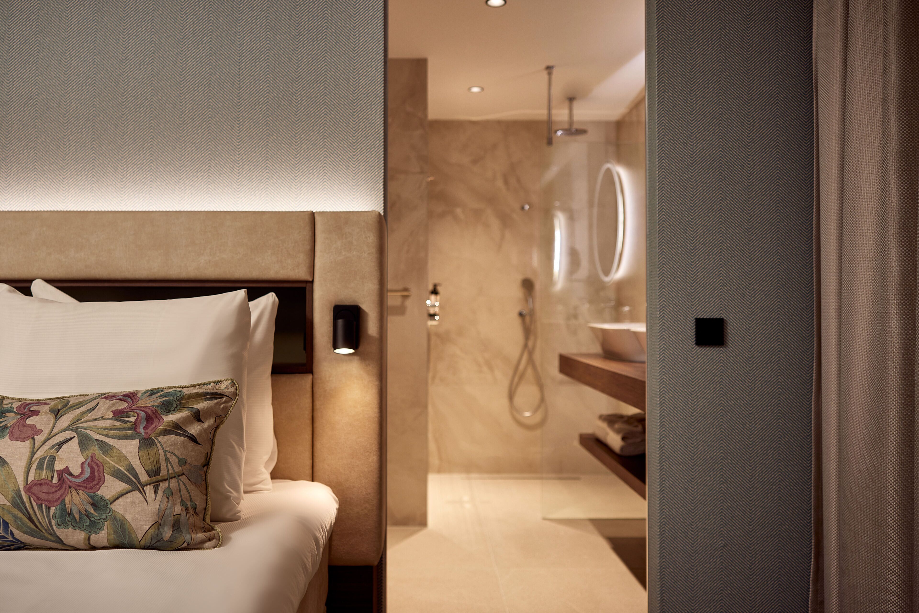A modern bathroom with a shower, a mirror, and a toilet.