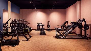 A gym with treadmills, weight machines, and free weights.