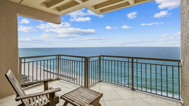 A balcony with a view of the ocean, a railing, and two wooden chairs. - 🌴 Beachfront Penthouse! Shore Elegance | 3BR | Destin Towers 151 ☀️ (Destin)