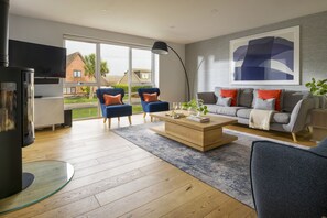 A modern living room with a fireplace, a sofa set, and a coffee table.