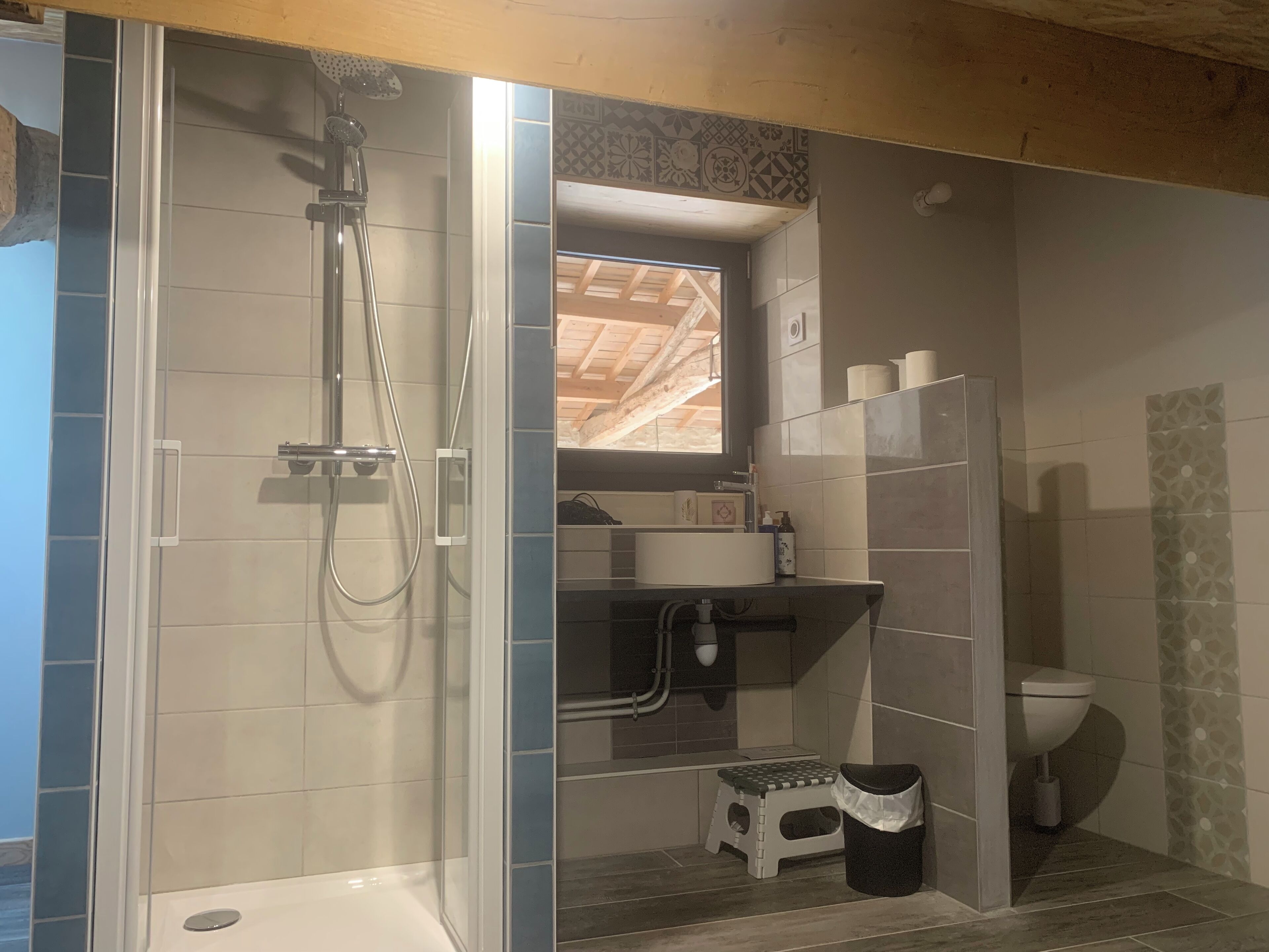 A bathroom with a shower, toilet, and sink.