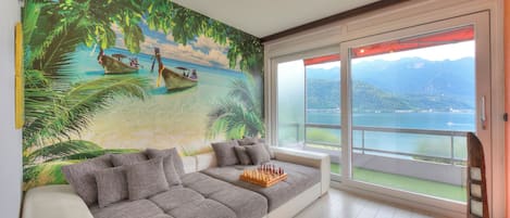 Family Apartment, Multiple Bedrooms (Melide On The Lake) | Living area | 21-inch TV with cable channels