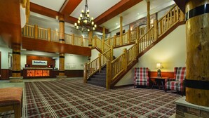 A spacious lobby with a grand staircase, a reception desk, and plaid chairs. - Worldmark Resort,3B2Bath!! Next to park! Sleeps 8 Very NICE (West Yellowstone)