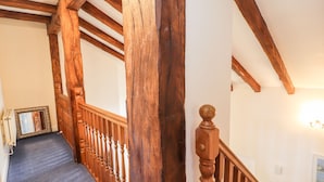 A wooden staircase with a blue carpet, wooden balusters, and a wooden handrail. - 45 Benton (Chester)