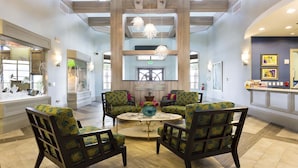 A spacious lobby with a high ceiling, wooden beams, and a central seating area with patterned chairs. - Last Minute Disney Getaway! Luxury Condo with Private Balcony. Book Now! #56633 (Orlando)