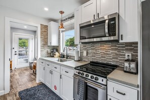 Fridge, microwave, oven, stovetop - Aqua Vista - Tiny Floating Cottage #1 (South Haven)