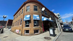 A corner building with 'Ben & Jerry's' signage, a brick facade, and a street view. - Michie House in College Hill - Hostel (Providence)