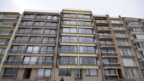 A multi-story residential building with balconies, a central entrance, and a sign reading "Le Sillage". - Apartment (Coxyde)