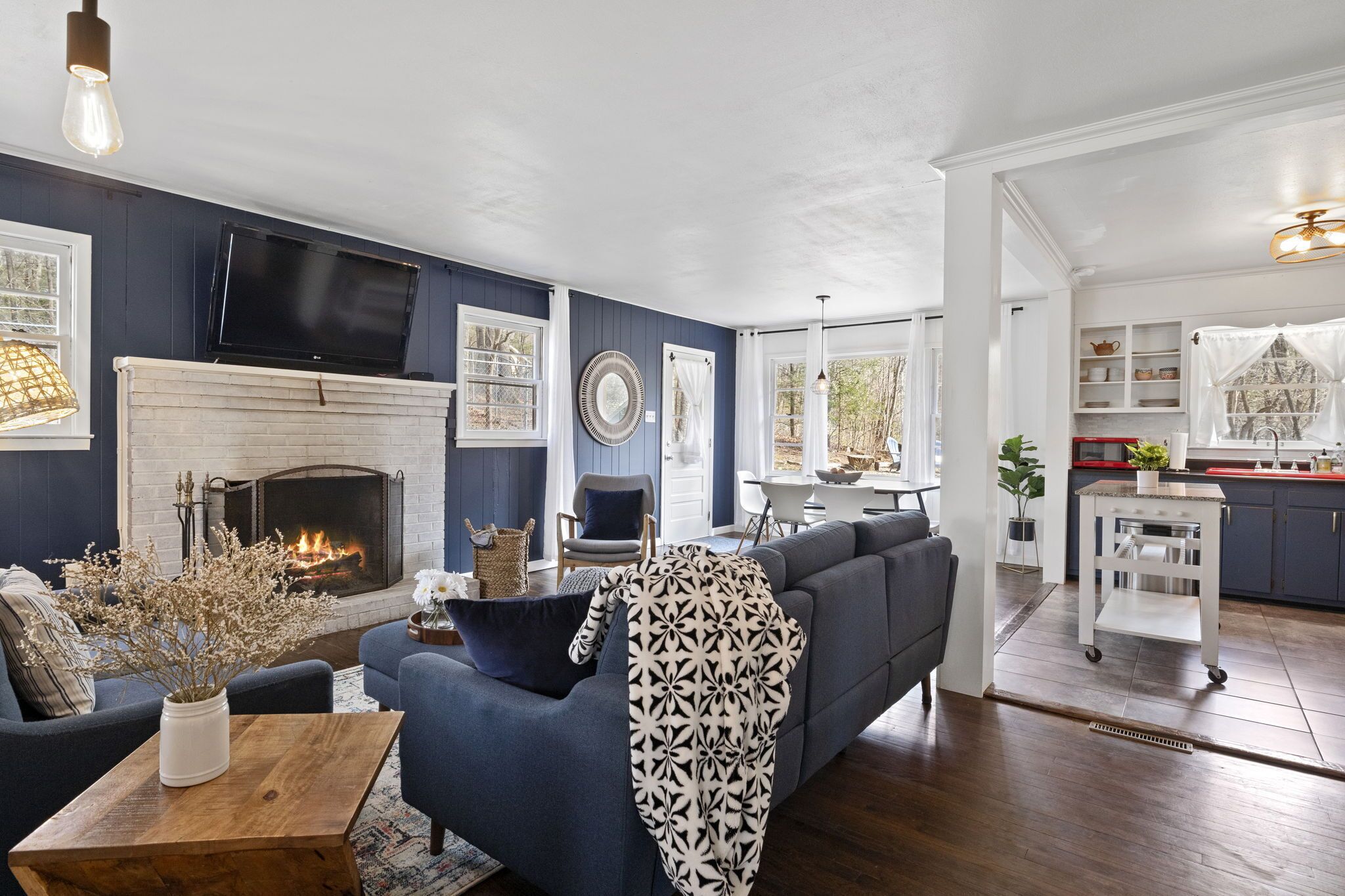 A living room with a fireplace, a sofa, a coffee table, and a television.