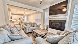 A living room with a sofa set, a coffee table, and a fireplace.
