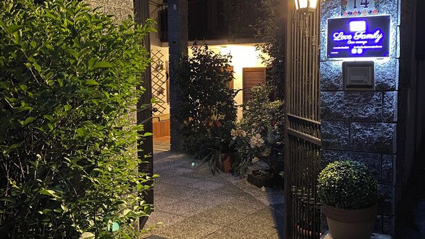 Un edificio in pietra con un cartello illuminato che riporta la scritta "Love Family".