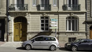 A historic building with a classic facade, multiple windows, and a prominent entrance with a golden door. - Hôtel Préfecture - 100m de l'Opéra - Encore Mieux (Limoges)