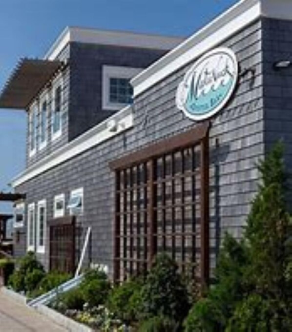Miller's features a two-story building with a dark-colored facade and a large window with a grid pattern on the second floor.