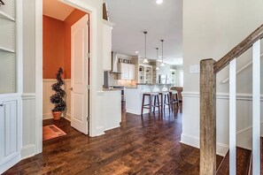 Enjoy cooking and dining in this open-plan kitchen and dining area, featuring a central island, oven, and comfortable seating.