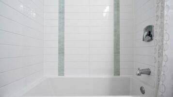 Combined shower/bathtub, hair dryer, towels, toilet paper
