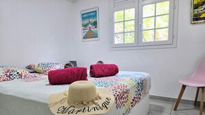 A bedroom with a bed, a chair, and a poster on the wall.