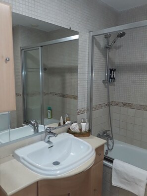 Bathtub, hair dryer, towels, soap