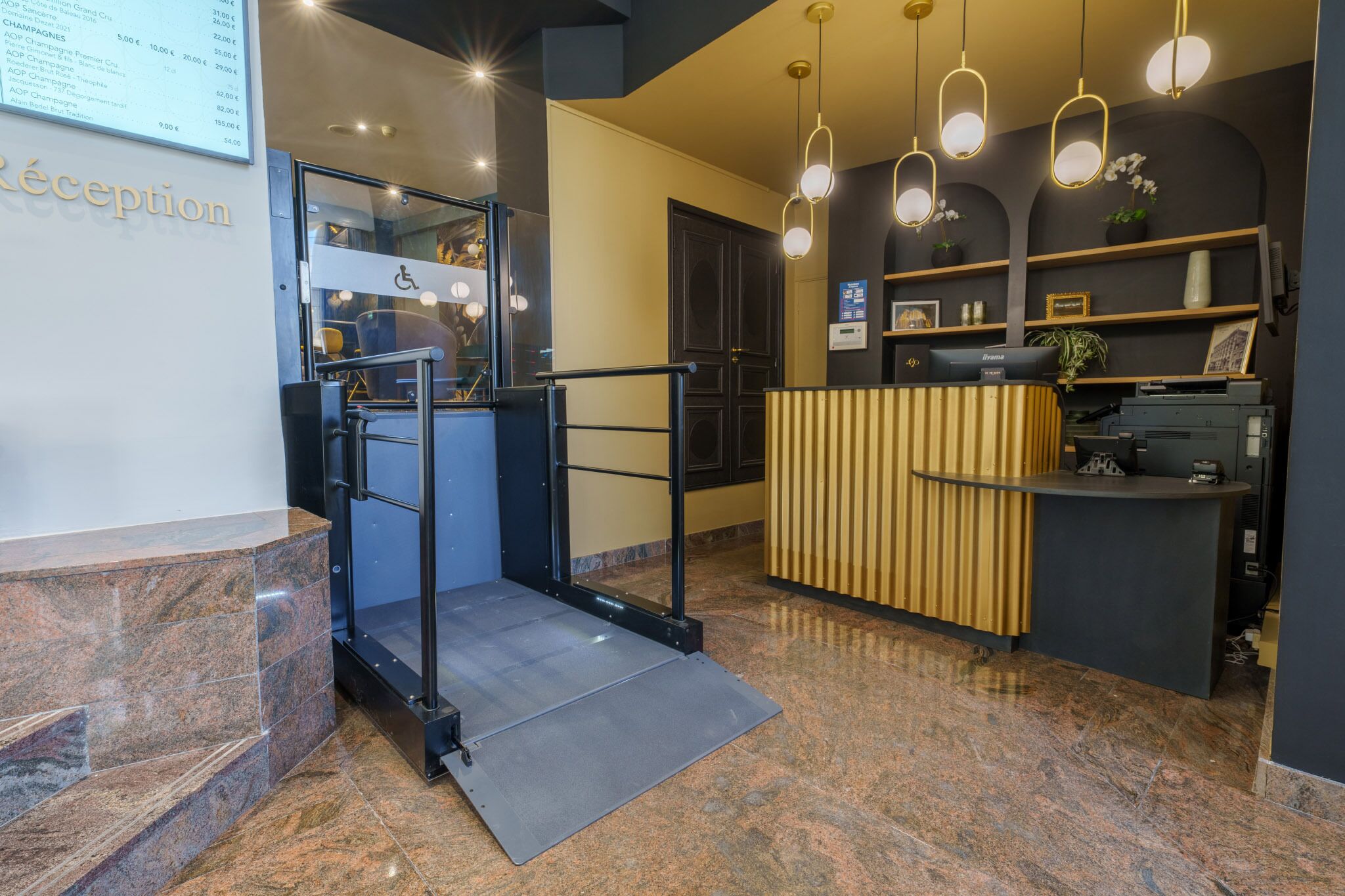 A reception area with a ramp, reception desk, and a wall-mounted menu board.