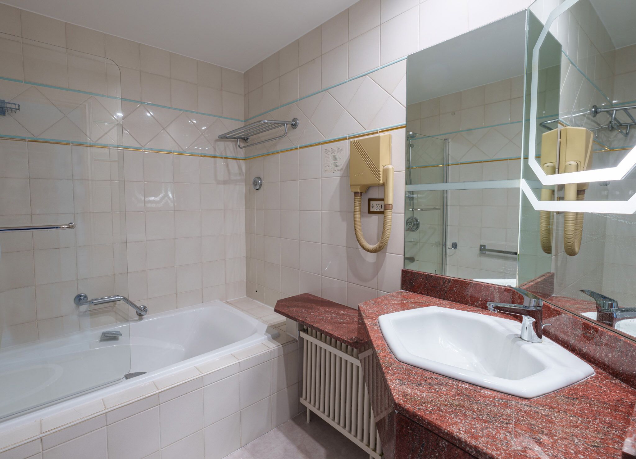 A modern bathroom with a bathtub, a sink, and a glass shower enclosure.