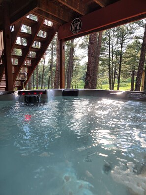 Un bain à remous avec une terrasse en bois et une enseigne indiquant « Old No. 7 Brand ».