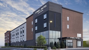 A modern hotel building with the name "Atwell Suites" prominently displayed.