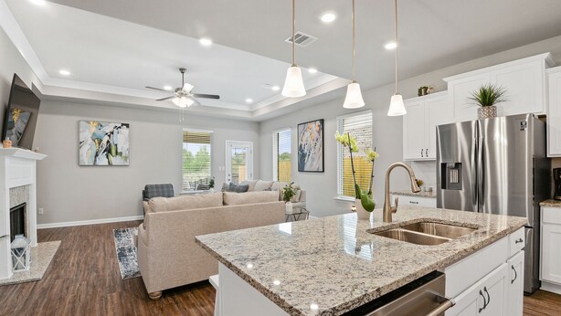 A modern kitchen with white cabinets, stainless steel appliances, and a granite countertop. - New Modern Home, Lakefront, Park & Pool, spacious 4br/3ba very safe place<br> (Baton Rouge)