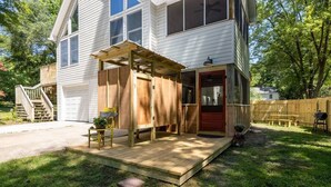 A two-story house with a covered patio, a garage, and a wooden deck. - "Calm it Down" Bikes, Beach, and 5 star reviews! (Kitty Hawk)