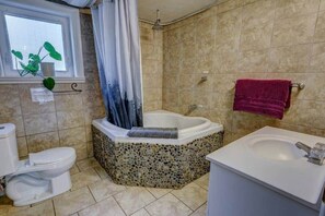 Bathtub, eco-friendly toiletries, hair dryer, towels