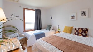A bedroom with two beds, a desk, a chair, and a window with curtains. - Auberge et Campagne (Saint Ferreol les Neiges)