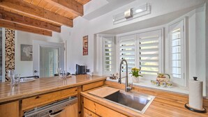 A modern kitchen with wooden countertops, a stainless steel sink, and a built-in dishwasher. - Crestline Cabin w/ Deck: 1 Mi to Lake Gregory (Crestline)