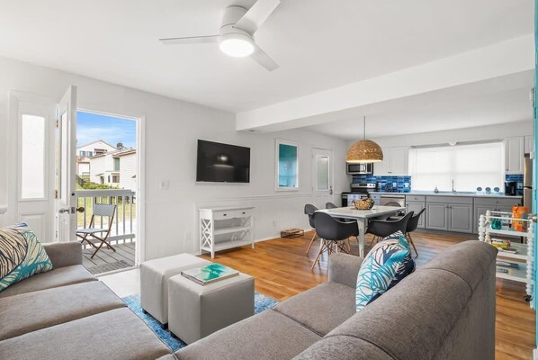Relax in this stylish living space with a comfortable sofa, dining area, and modern kitchen.