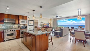 A modern kitchen with a central island, stainless steel appliances, and pendant lighting. - Maui Resort Rentals: Honua Kai Konea 929 – 9th Floor 3BR W/ Stunning Ocean Views from All 3 Bedrooms! (Lahaina)