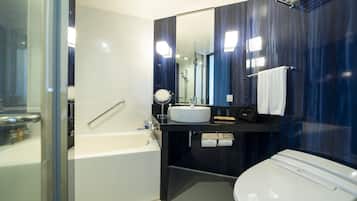 A modern bathroom with a bathtub, a sink, and a toilet.