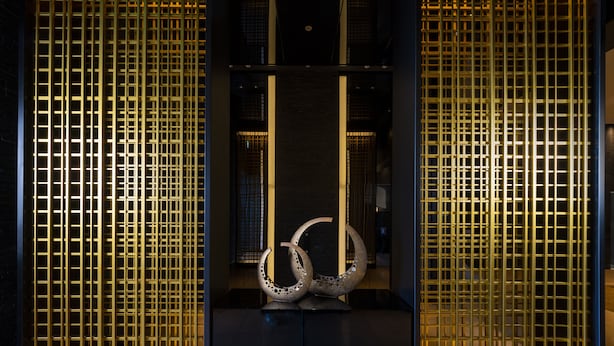 A modern interior with a central sculpture, enclosed by vertical metal panels. - KOKO HOTEL Premier Kumamoto (Kumamoto)