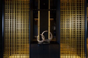 A modern interior with a central sculpture, enclosed by vertical metal panels. - KOKO HOTEL Premier Kumamoto (Kumamoto)
