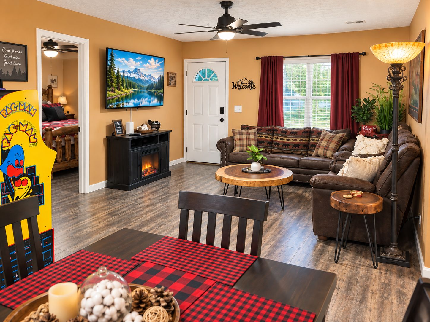 A cozy living room with a fireplace, a sofa, a coffee table, and a dining area with a checkered tablecloth.