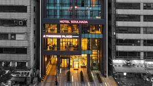 A modern hotel building with a glass facade, signage for 'HOTEL SOULHADA' and 'A TWOSOME PLACE', and a visible entrance. - Hotel Soulhada (Incheon)