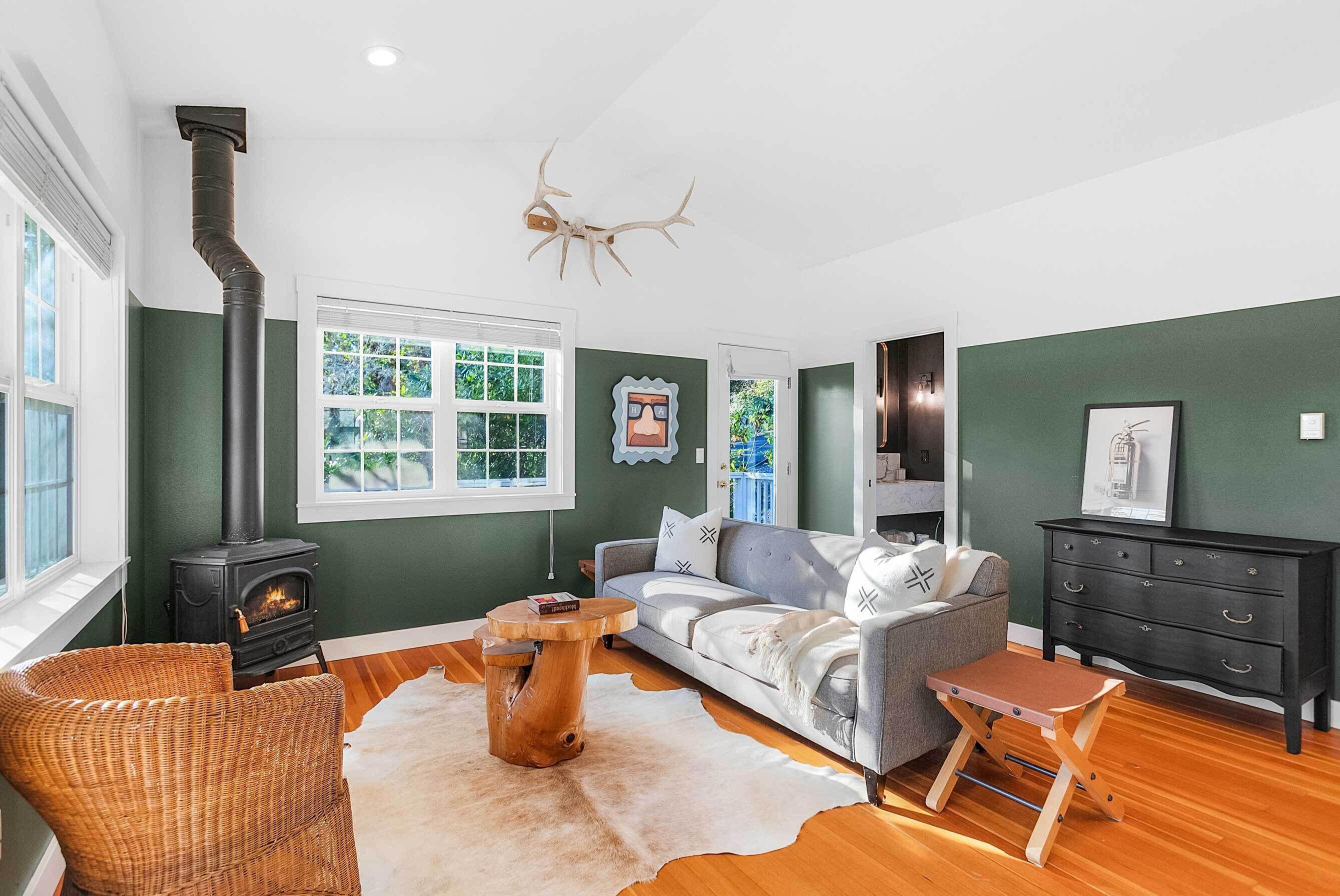 A cozy living room with a fireplace, a sofa, a coffee table, and a chair.