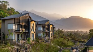 A modern resort with multiple buildings, a winding pathway, and a mountainous backdrop. - Norbu The Montanna, Dharamshala - IHCL SeleQtions (Dharamshala)